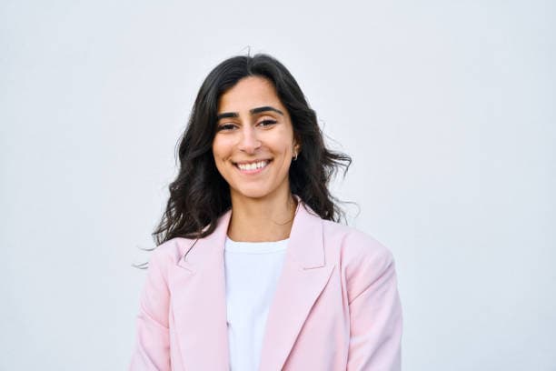 Student in pink blazer smiling